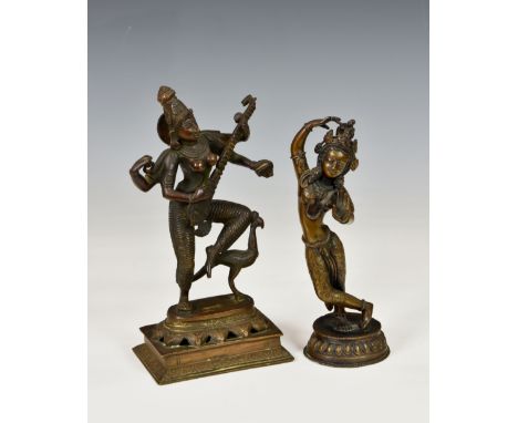 A bronze Hindu Saraswati figure playing a lute with bird beside, raised on rectangular and lotus base, 9¼in. (23.5cm.) high; 