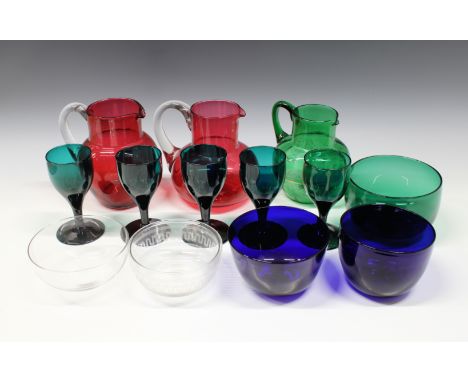 A collection of 19th and 20th century glass to include two cranberry jugs, an emerald green and enamel jug, five Bristol or e