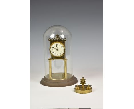 A brass anniversary clock with glass dome by Badische Uhrenfabrik, Arabic white enamel dial, typical brass frame and single t