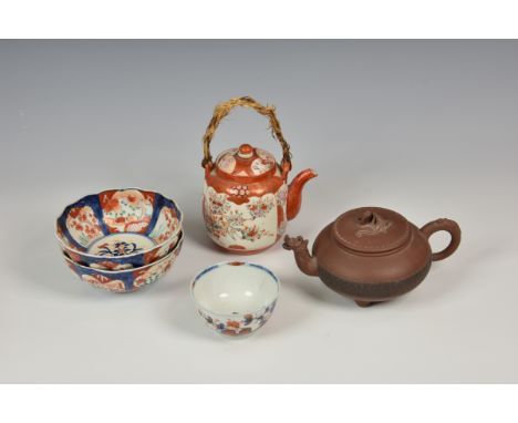 A small collection of Chinese and Japanese porcelain comprising a Chinese export Imari tea bowl, hairline; a Yixing teapot wi