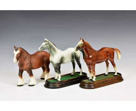 Two Beswick style pottery horses same pattern in two colour ways, grey and brown, each standing on turned wooden oval plinths