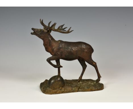 A bronze of a bellowing stagraised on naturalistic base, unmarked, overall length 8in. (20.3cm.).