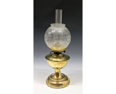 An antique / vintage brass oil lamp of typical form with replacement floral etched shade, 20¾in. (52.7cm.) total height.