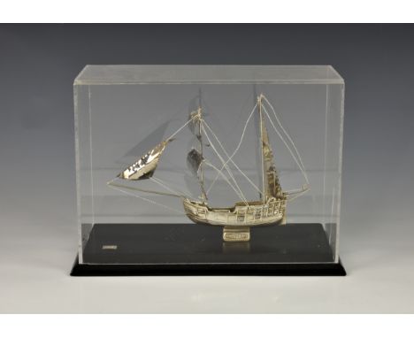 A miniature Continental sterling silver model of a galleon marked 'SILVERO', sitting on rectangular wooden base with perspex 