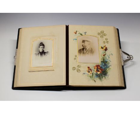 A Victorian Art Nouveau style photograph album the black leather covers with Art Nouveau style decoration and end papers with