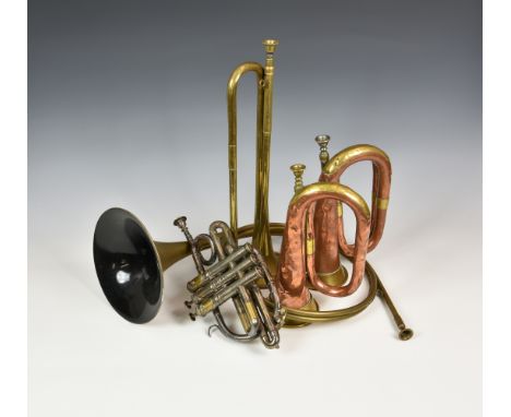 A small collection of World War One period and later instruments comprising two copper and brass bugles, the first stamped wi