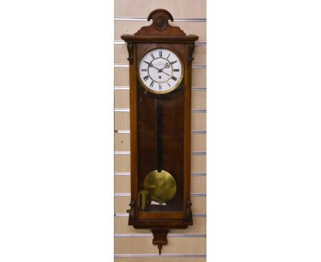 A late 19th century walnut Viennese style wall clock, the white Roman enamel dial signed 'Gould Bury &amp; Ramsbottom', singl