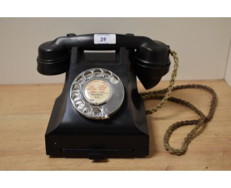 A 20th Century bakelite rotary dial telephone