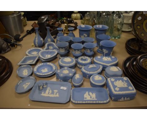 A large assortment of Wedgewood Jasperware including trinket boxes, urns and vases.