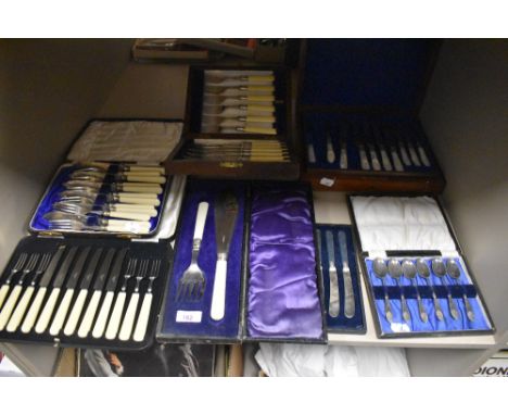 An assortment of boxed cutlery and flatware including a set of butter knifes, teaspoons, mother of pearl cake knife and fork 