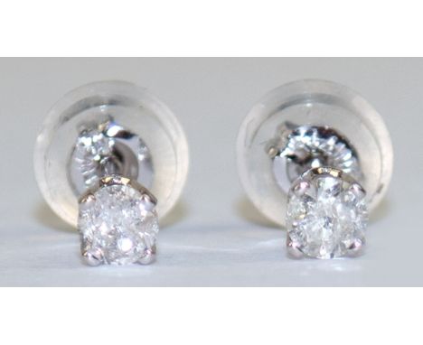 Ohrstecker, 14 k WG, Brillanten zus. ca. 0,23 ct., Aufstecker aus Silikon mit Goldinlay, ungetragen