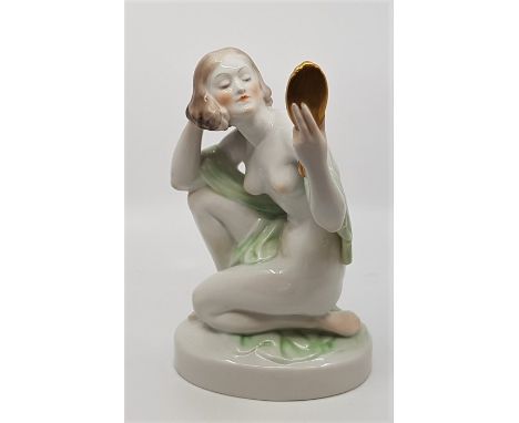 A Herend hand painted porcelain figurine, model no.5724, in the Art deco style, of a knelling lady looking into a hand mirror