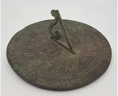 A sundial, with eight point compass rose, diameter 20.2cm.