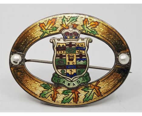A Canadian silver and polychrome enamel oval brooch, relief impressed makers mark for Richard Hemsley and "Rd.Pat.1909 - Ster