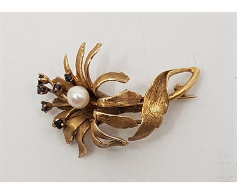 A 14ct. gold, sapphire and cultured pearl set "flower" brooch,&nbsp;with textured petals and leaves, set single cultured pear