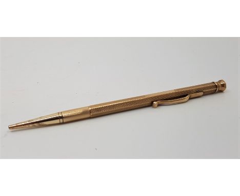 A Baker's Perm-Point 9ct. gold engine turned propelling pencil, by E Baker & Son, assayed Birmingham 1930, stamped maker and 