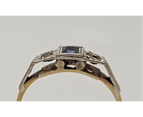 An Art Deco style 18ct. gold, platinum, sapphire and diamond ring, set table cut sapphire to centre flanked by single illusio