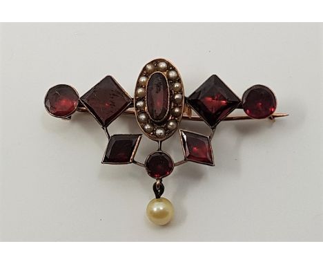 A Victorian precious yellow metal, carbuncle and pearl set brooch.&nbsp;(precious yellow metal assessed as gold of 15ct. or h