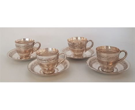 A set of four Burmese silver coffee cups and saucers, repousse foliate band, stamped to base "95% Silver Burma", the cups hei