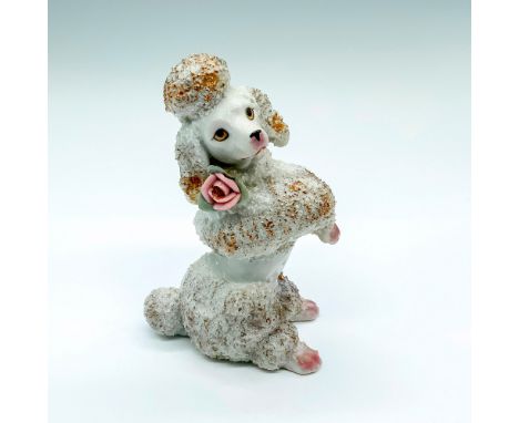 Vintage white porcelain poodle with gold accents and pink flower on neck. Dimensions: 4"L x 2.25"W x 6"HCondition: Age relate