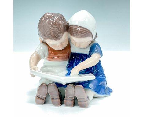 Elegant glossy porcelain figurine portraying a girl and a boy reading a book #1567. Bing and Grondahl backstamp. Artist: Inge