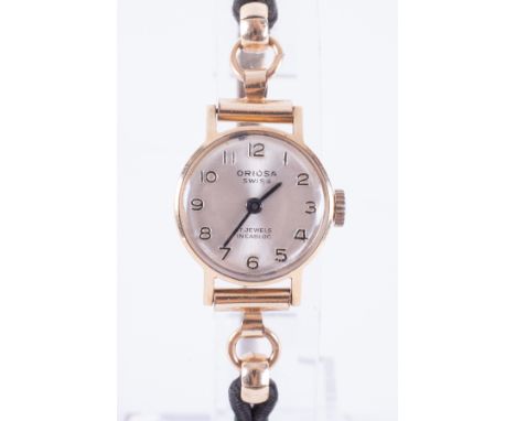 Oriosa, a ladies vintage 9ct yellow gold cased Oriosa manual wind wristwatch with a rolled gold and black fabric strap, 11.60