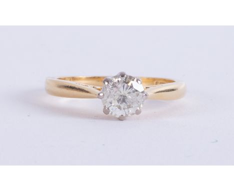 An 18ct yellow &amp; white gold solitaire set with a round brilliant cut diamond, approx. 0.82 carats, approx. colour K and S