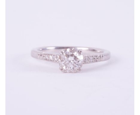 A platinum ring set with a central round brilliant cut diamond, 0.74 carats, colour G &amp; SI1 clarity, excellent cut, polis