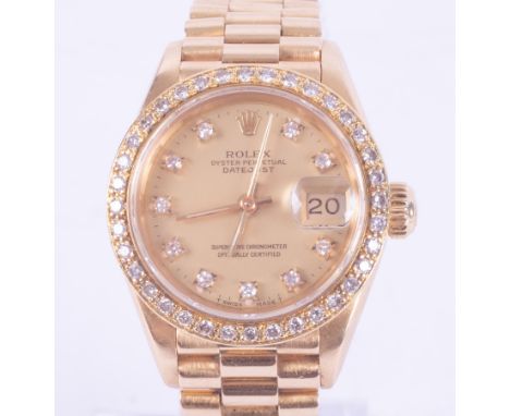 Rolex, a ladies 18ct yellow gold automatic Rolex Oyster Perpetual Datejust chronometer with diamond set bezel and diamond dot