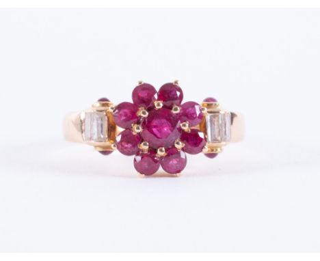 A yellow gold ring (looks to be of high carat but no hallmarks &amp; not tested) of a flower design set with round cut rubies