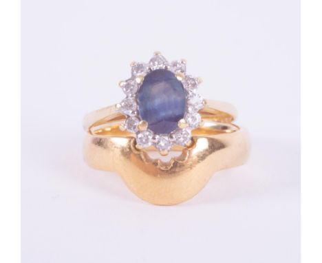 A set comprising of an 18ct yellow &amp; white gold cluster design ring set with a central blue sapphire, approx. 0.80 carats