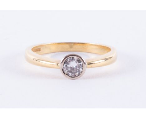An 18ct yellow &amp; white gold ring set with a round brilliant cut diamond, approx. 0.25 carats (the stone was measured in t