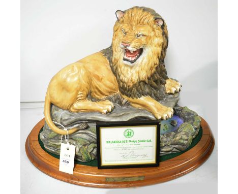 A large Renaissance Design ceramic model of a lion, modelled on naturalistic base, designed by Howard J. Wedgwood, modelled a