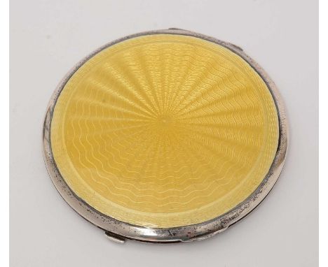 A guilloche enamel and silver compact, by Crisford &amp; Norris, Birmingham 1933, with yellow enamel design, 8.5cms diameter.