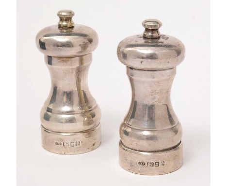 A pair of silver pepper mills, by David R Mills, London 1994, of typical form. 