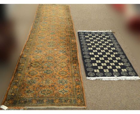 A Turkoman runner, 360 x 84cms; and another contemporary abstract rug, 135 x 69cms. 