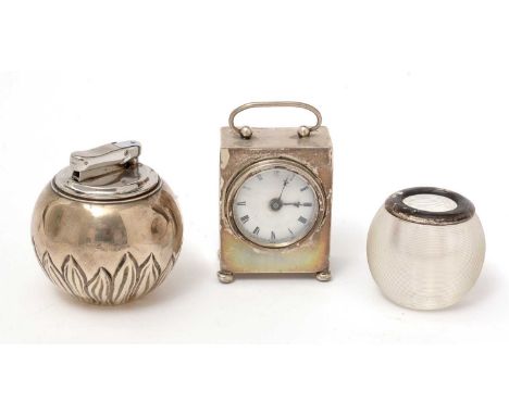 A silver dressing table clock, by Cohen &amp; Charles, Chester; a silver 'Witch Ball' pattern table lighter, by Comyns London