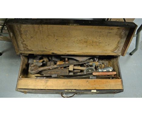 A collection of wood working and other tools, contained together in a stained pine tool box. 