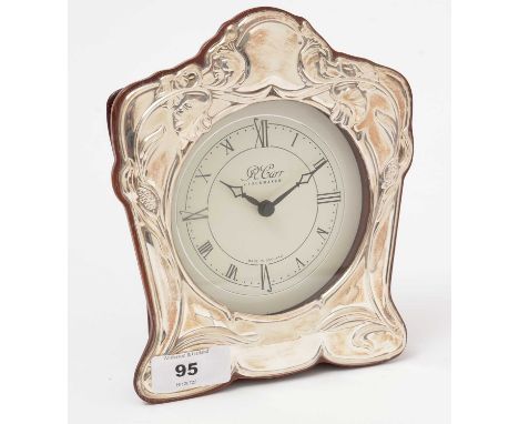 A modern silver mounted table clock, by R. Carr, of floral design on wooden mount.