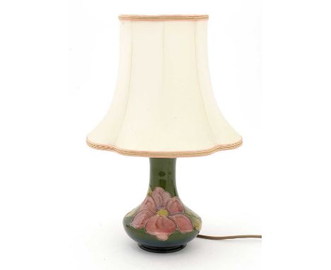 A Moorcroft Hibiscus pattern lamp, the base tube lined with flowers on a graduated green ground, cream fabric shade, unmarked