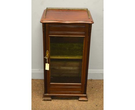 Bowman Bros, Camden Town, London (1871-1915): an Edwardian mahogany music cabinet with quarter brass gallery to serpentine to