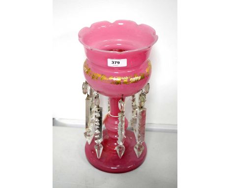 A Victorian pink glass lustre, decorated with gilt and enamel foliate designs, crystal lustre drops, 30cms high.