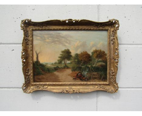 A 19th Century Norwich School oil on wooden panel depicting figures making camp near a bridge, river landscape in the distanc