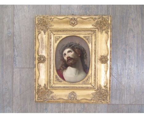 A late 19th Century hand painted porcelain oval panel depicting Christ, probably by KPM. Set in an ornate gilt frame with lab