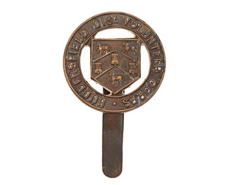 Huddersfield District Volunteer Corps WW1 cap badge.  Good scarce die-cast tile circlet with shield bearing Arms to voided ce
