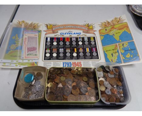 A tray containing a Cleveland historical campaign medals folder, a quantity of foreign and pre decimal British coinage, Esso 