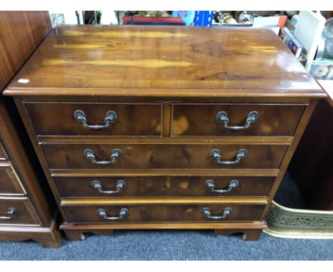 An inlaid yew wood five drawer chest on bracket feet.  