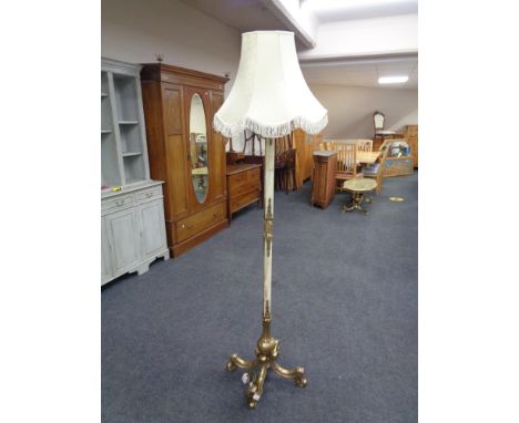 An ornate, heavy brass and onyx ornate standard lamp with shade. 