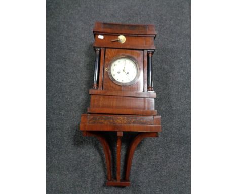 An early 20th century mahogany cased continental bracket clock with shelf. 