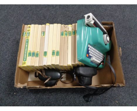 A box containing children's encyclopedias, a toy typewriter together with two vintage cameras. 